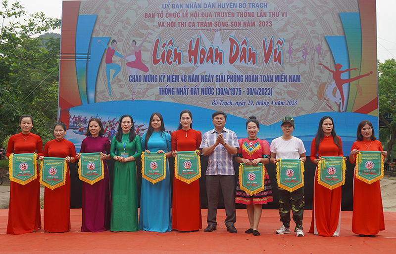Đại diện lãnh đạo Phòng Văn hóa-Thông tin và Hội LHPN huyện Bố Trạch trao cờ lưu niệm cho các đội tham gia liên hoan.